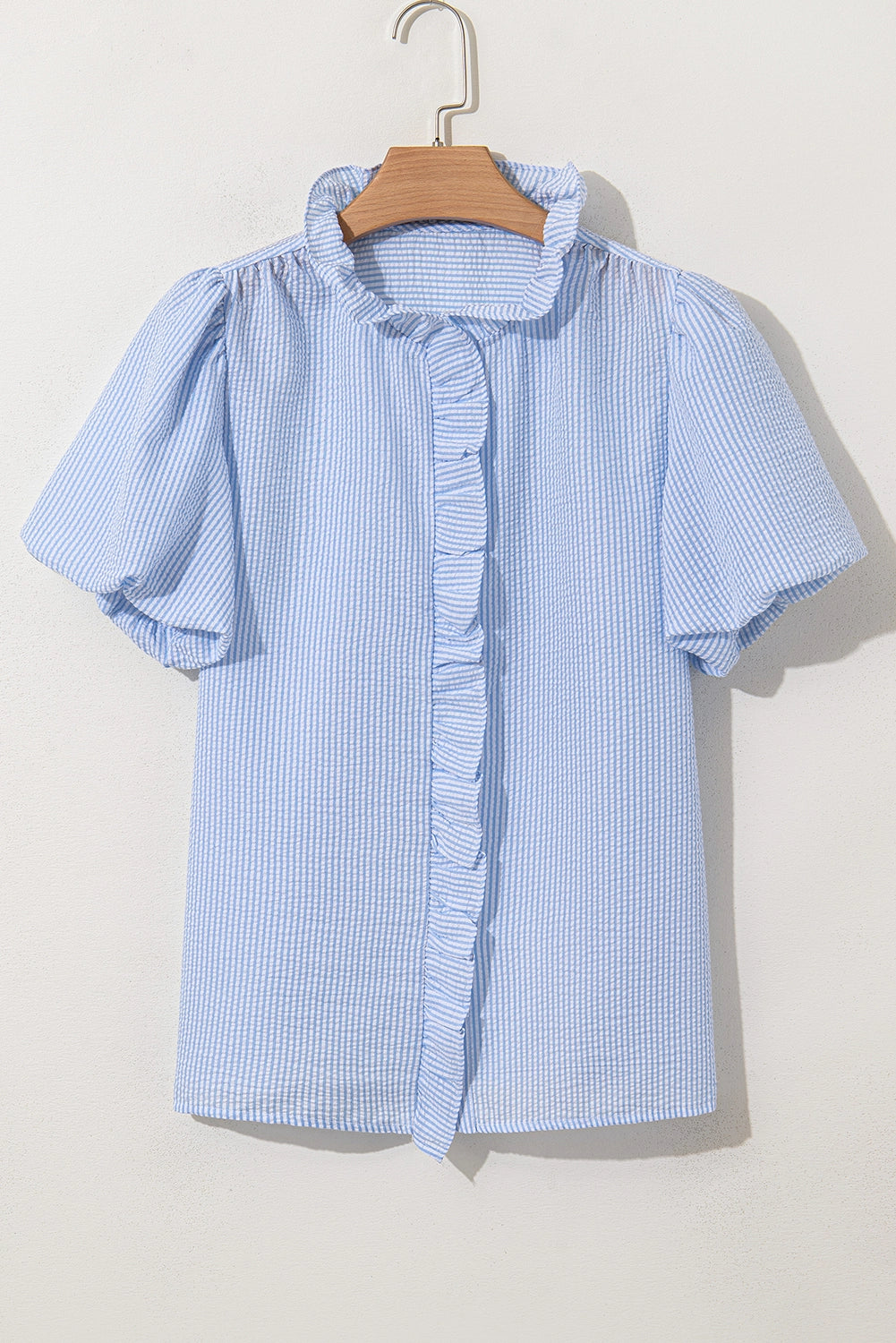 Seersucker ruffle trim bubble sleeve top.&nbsp;

Size up for more room in chest and arm opening.
100% Polyester
Delicate wash, hang to dry.