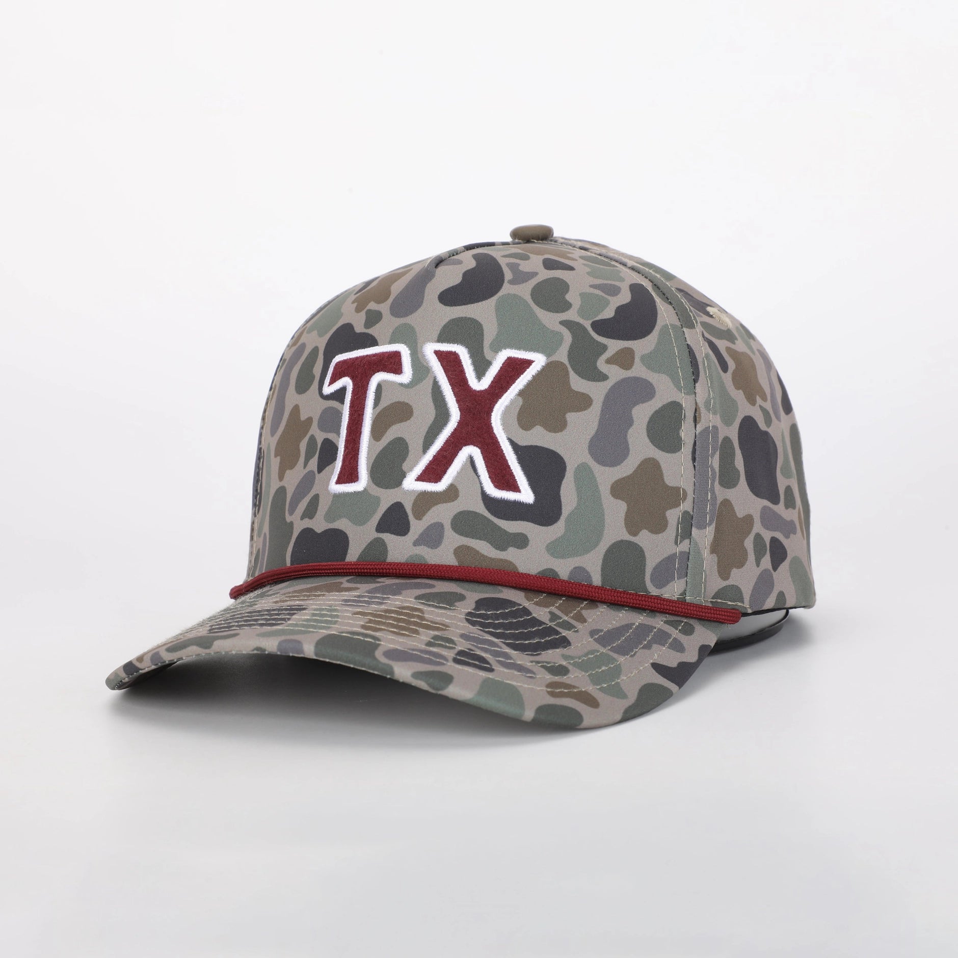 Camouflage cap with 'TX' logo on a white background
