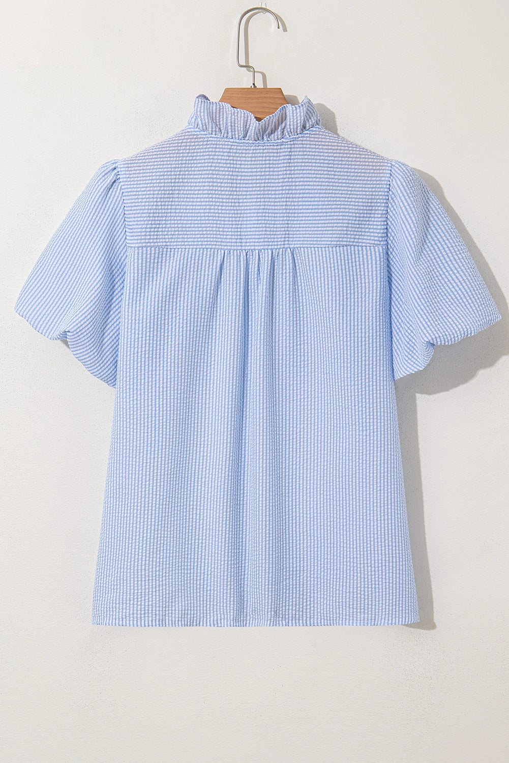 Seersucker ruffle trim bubble sleeve top.&nbsp;

Size up for more room in chest and arm opening.
100% Polyester
Delicate wash, hang to dry.
