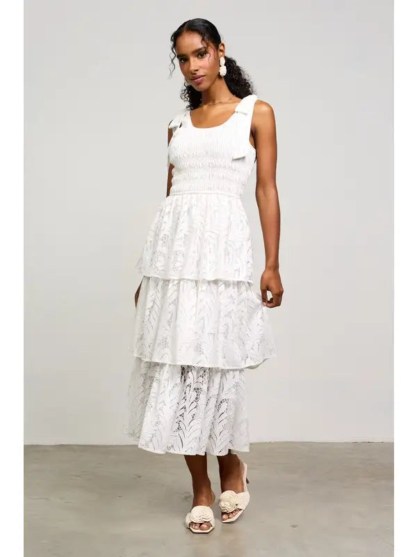 White lace tiered midi dress with bow straps.

X-Small (Size 2-4) Bust: &nbsp;33.5", Waist: &nbsp;26", Hips 36"
Small (Size 4-6) Bust: 35.5", Waist: &nbsp;27.5", Hips: 37.5"
Medium (Size 8-10) Bust: 37.5", Waist: &nbsp;29.5", Hips: 39.5"
Large (Size 12)Bust: 39.5" Waist: &nbsp;31.5", Hips: &nbsp;41.5"
80% Cotton, 20% Polyester
Delicate wash, hang to dry.
Made by Skies are Blue