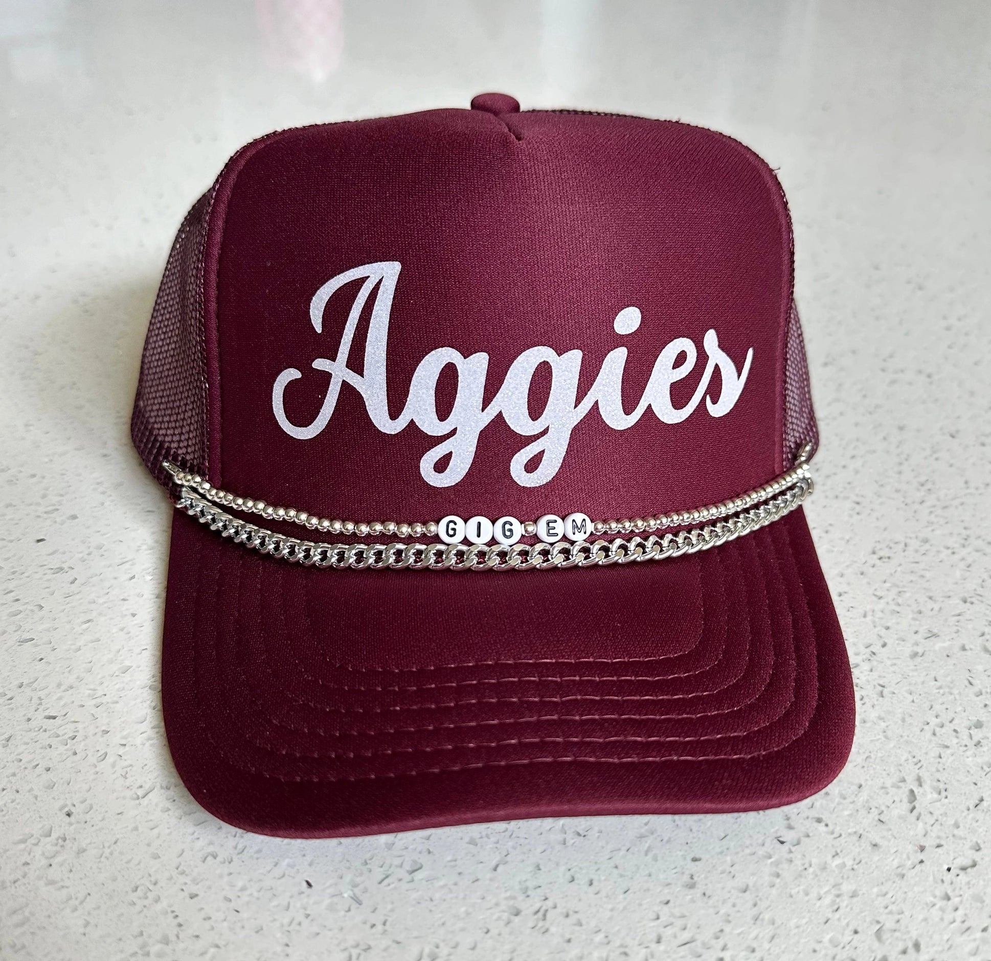 Aggies trucker cap.

2 chains with Gig Em beads.
High quality Otto brand cap.