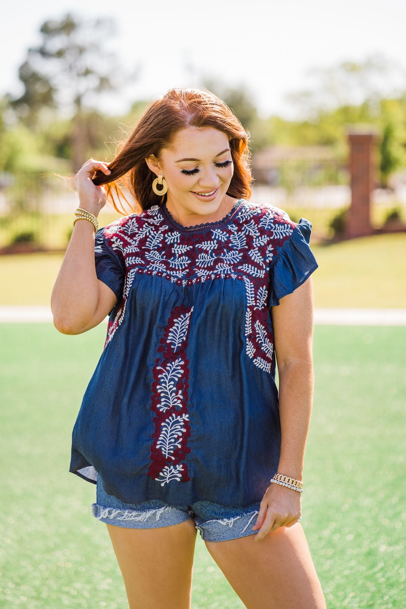 Denim with maroon and white embroidery.  HAND WASH/DELICATE ONLY in cold water and hang to dry 74% Tencel, 24% Polyester, 2% Spandex Made by Layerz L (12-14) bust: 46" length: 28" sleeve length: 3 1/2"  XL (16-18) bust: 50" length: 28" sleeve length: 3 1/2" 