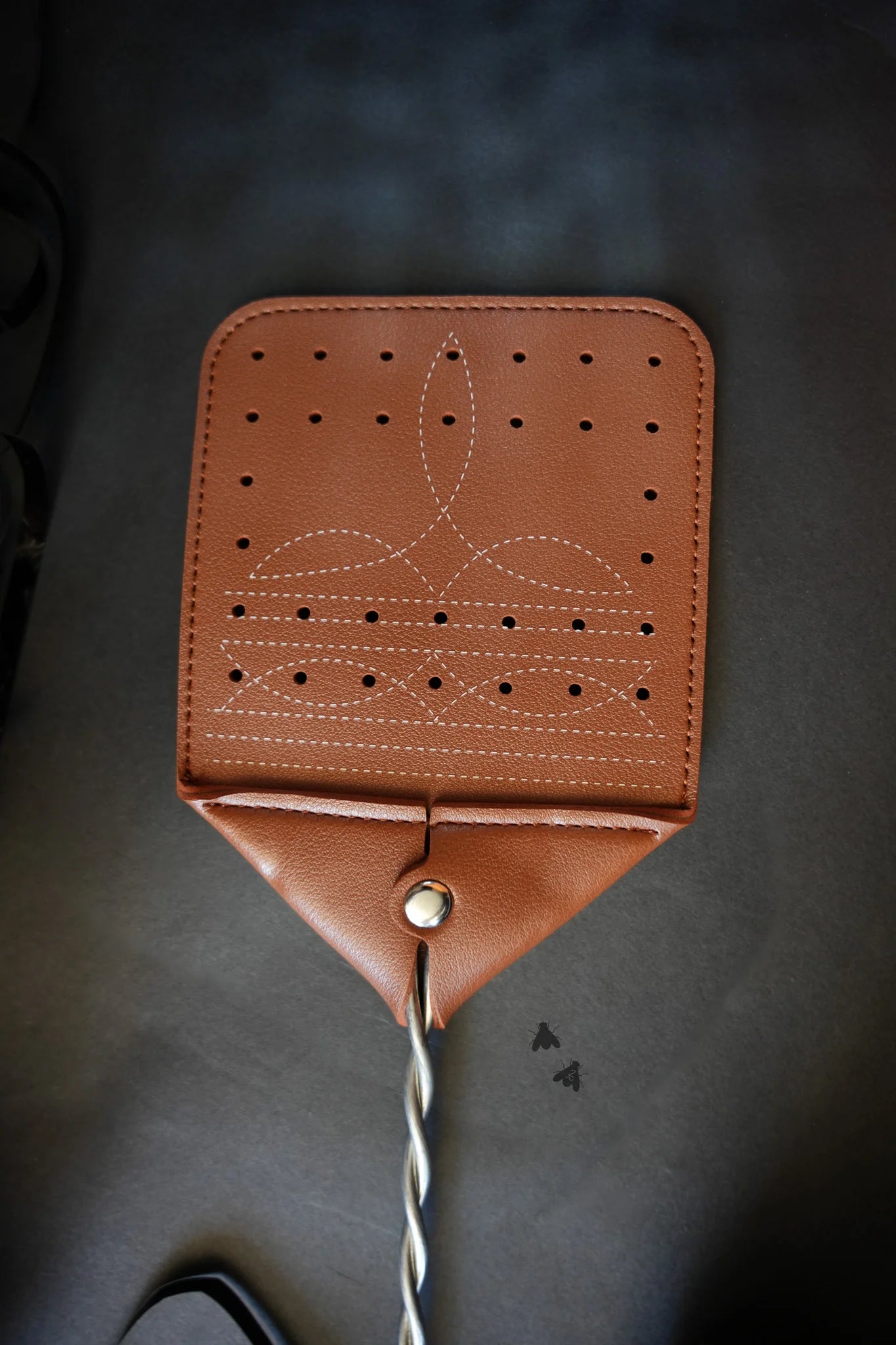 Boot stitch faux leather fly swatter. &nbsp;

19.5" x 4.25"
Faux leather tan with boot stitching.
Elevate your fly killing.
Made by 2 FLY