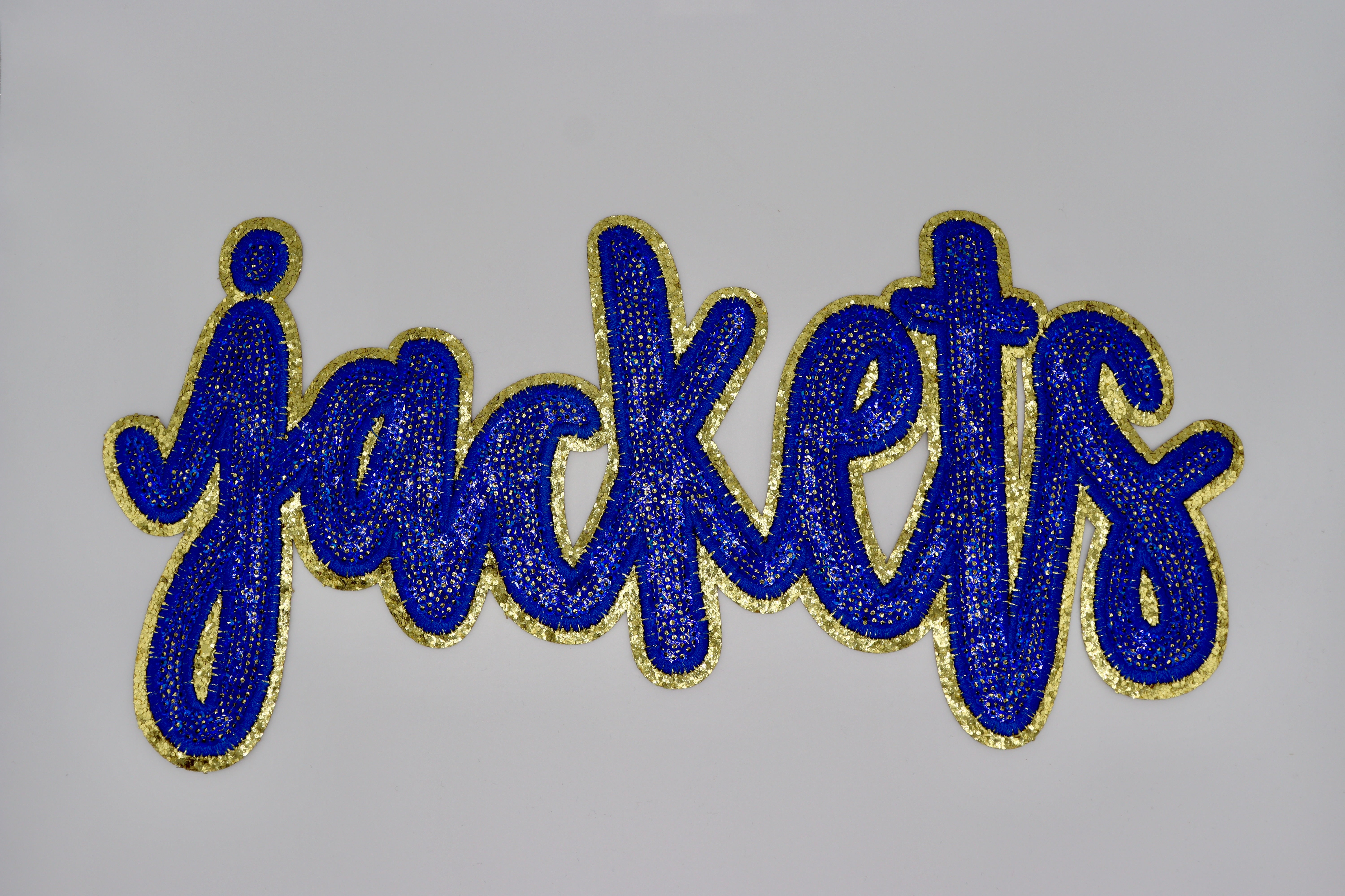 Blue and gold sequin Jackets patch. &nbsp;

12" wide
Heat press on garments &gt; 50% polyester.
CANNOT be pressed on with an iron, must use heat press.
Follow heat press instructions for successful application.