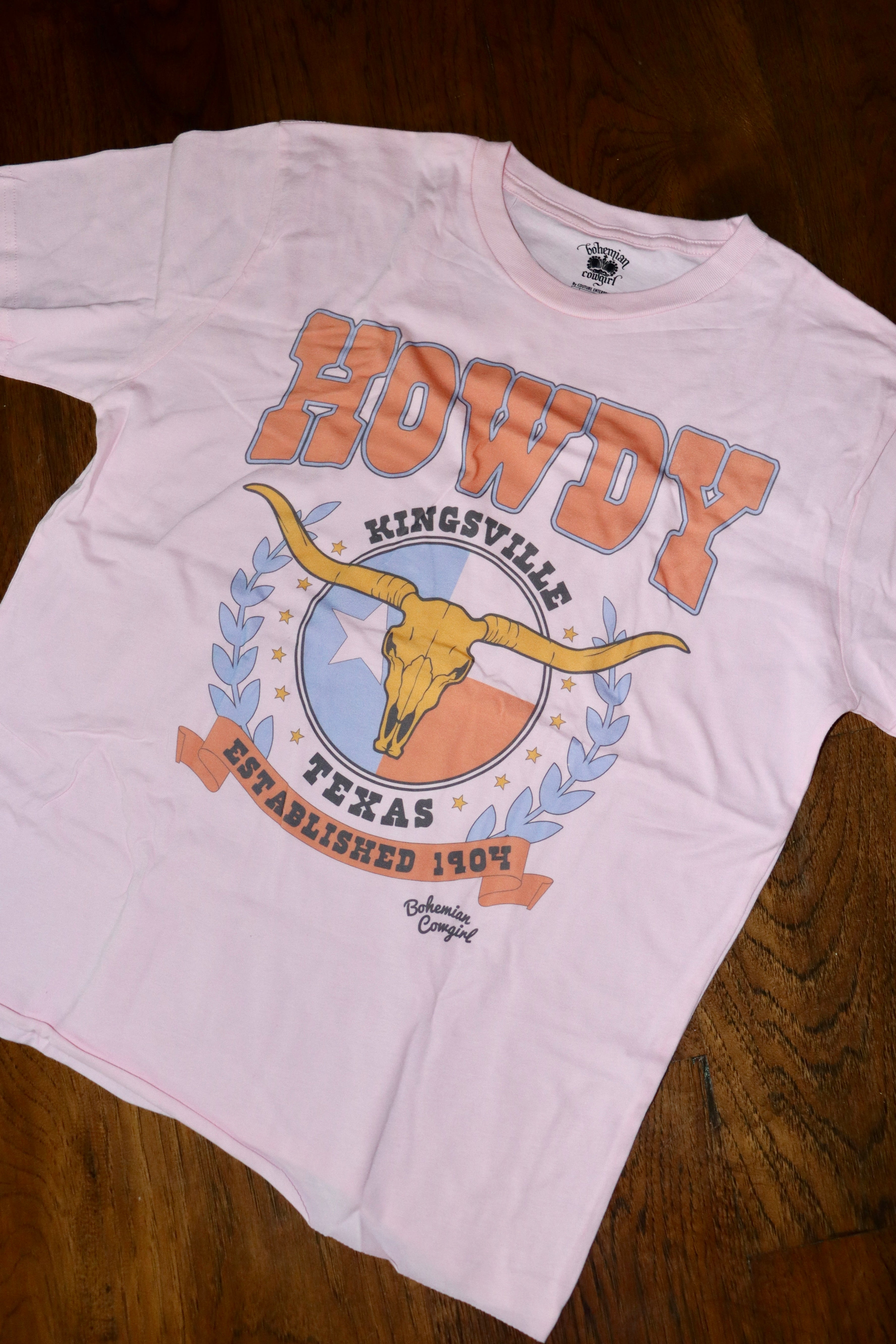 Light Pink t-shirt featuring Kingsville, Texas.

Raw hem long crop.
True to size.
100% Cotton
Wash cold, hang or lay flat to dry- NO DRYER.
Made by Bohemian Cowgirl.