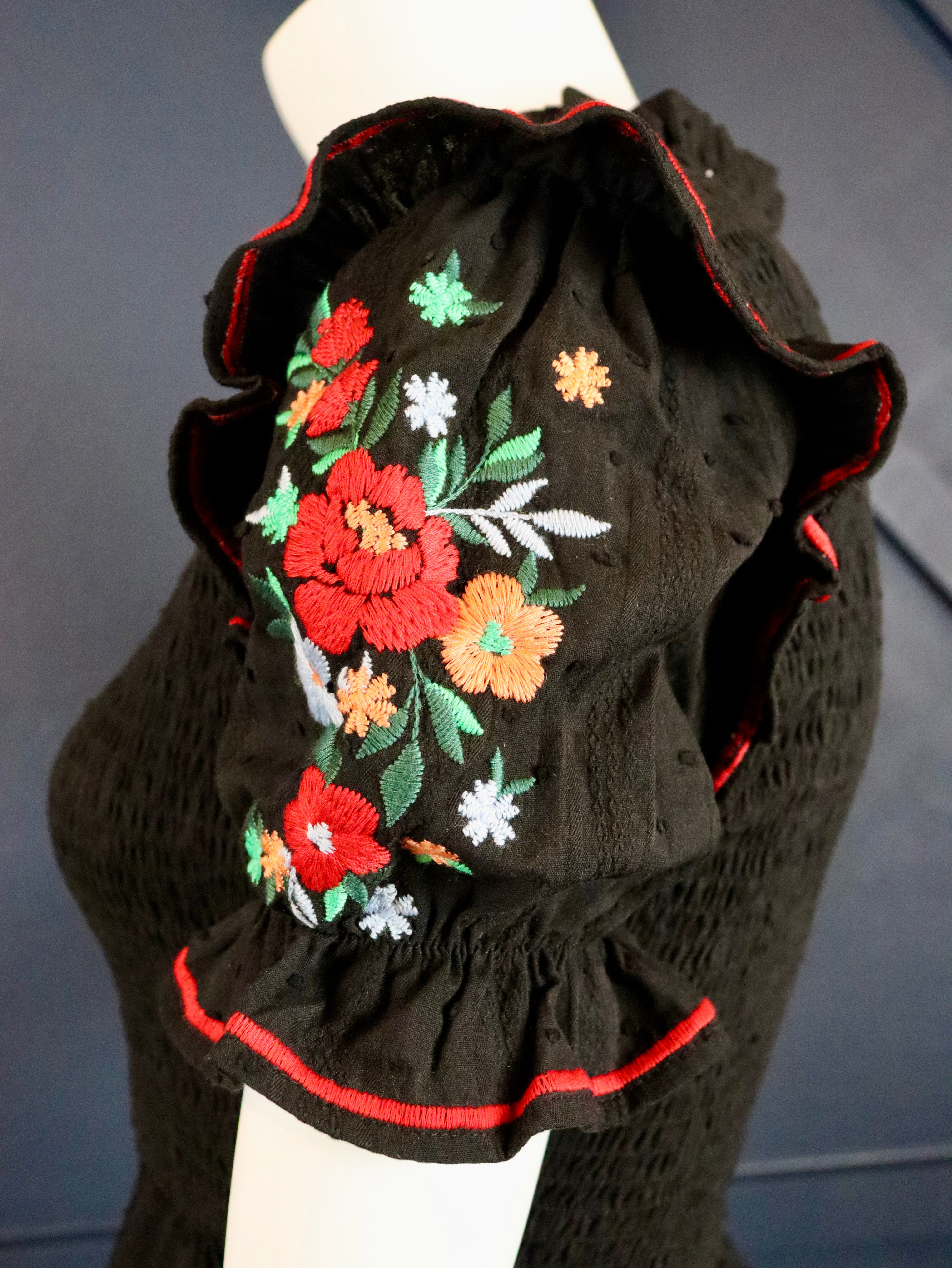This black smocked embroidered top pairs well with white denim. 
Floral embroidered short puffy sleeves with a smocked bodice.
100% Cotton
Made by Savanna Jane
Small (0-2)
Medium (4-6)
Large (8-10)