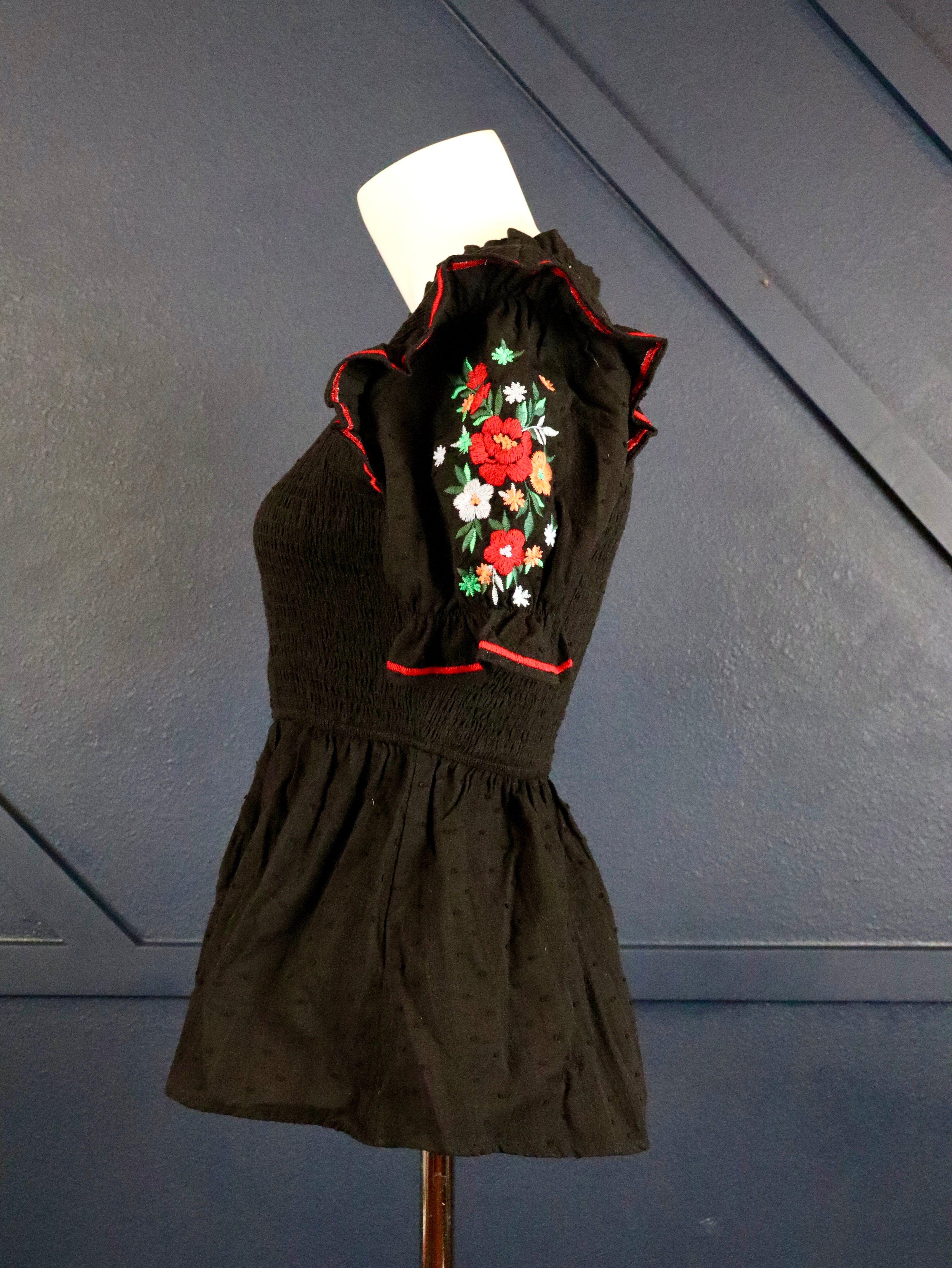 This black smocked embroidered top pairs well with white denim. 
Floral embroidered short puffy sleeves with a smocked bodice.
100% Cotton
Made by Savanna Jane
Small (0-2)
Medium (4-6)
Large (8-10)