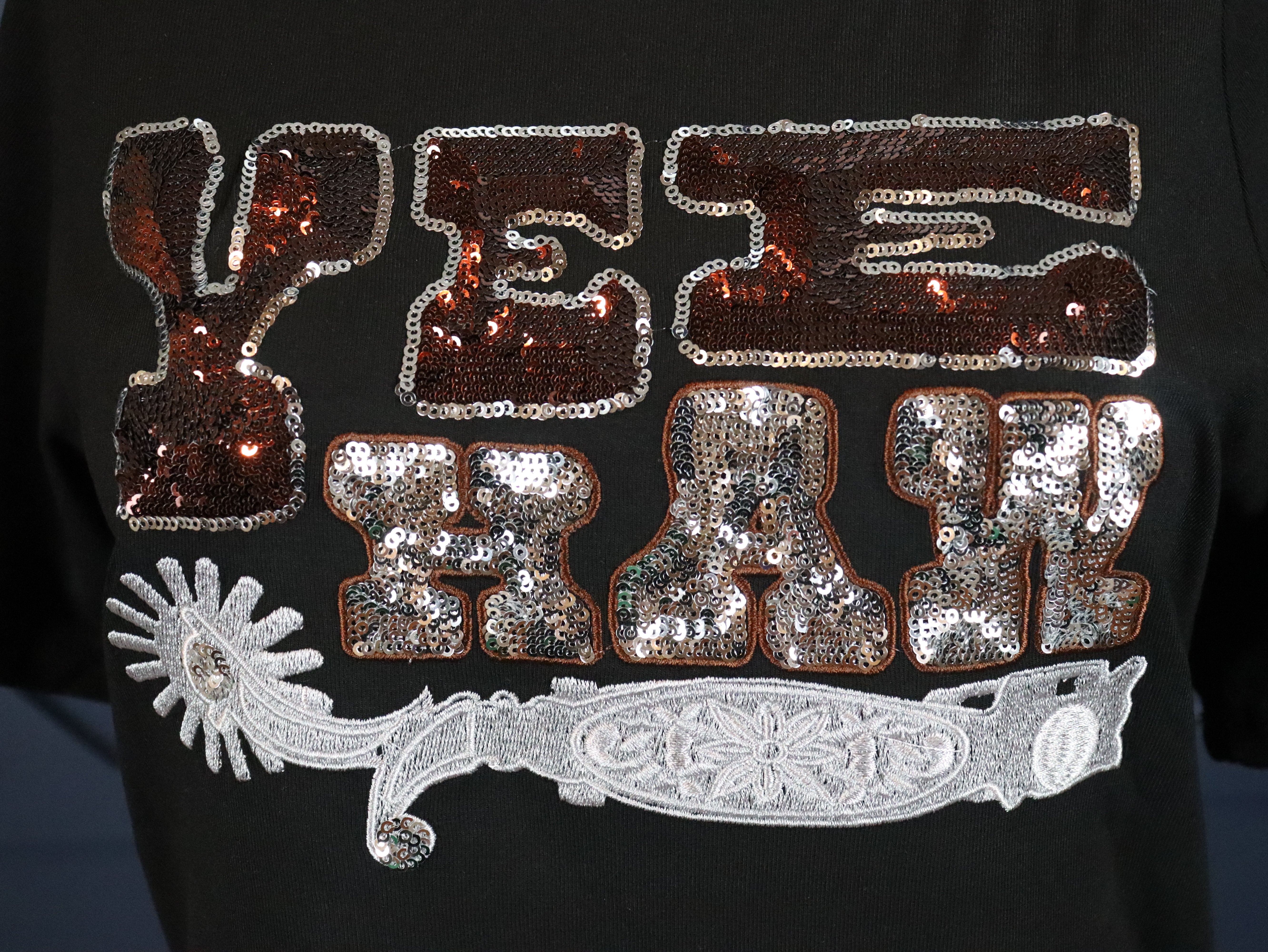 Black t-shirt with sequin Yee Haw. 
95% Rayon, 5% Spandex
Fitted.
Delicate wash inside out, tumble dry low.
Made by 2 FLY