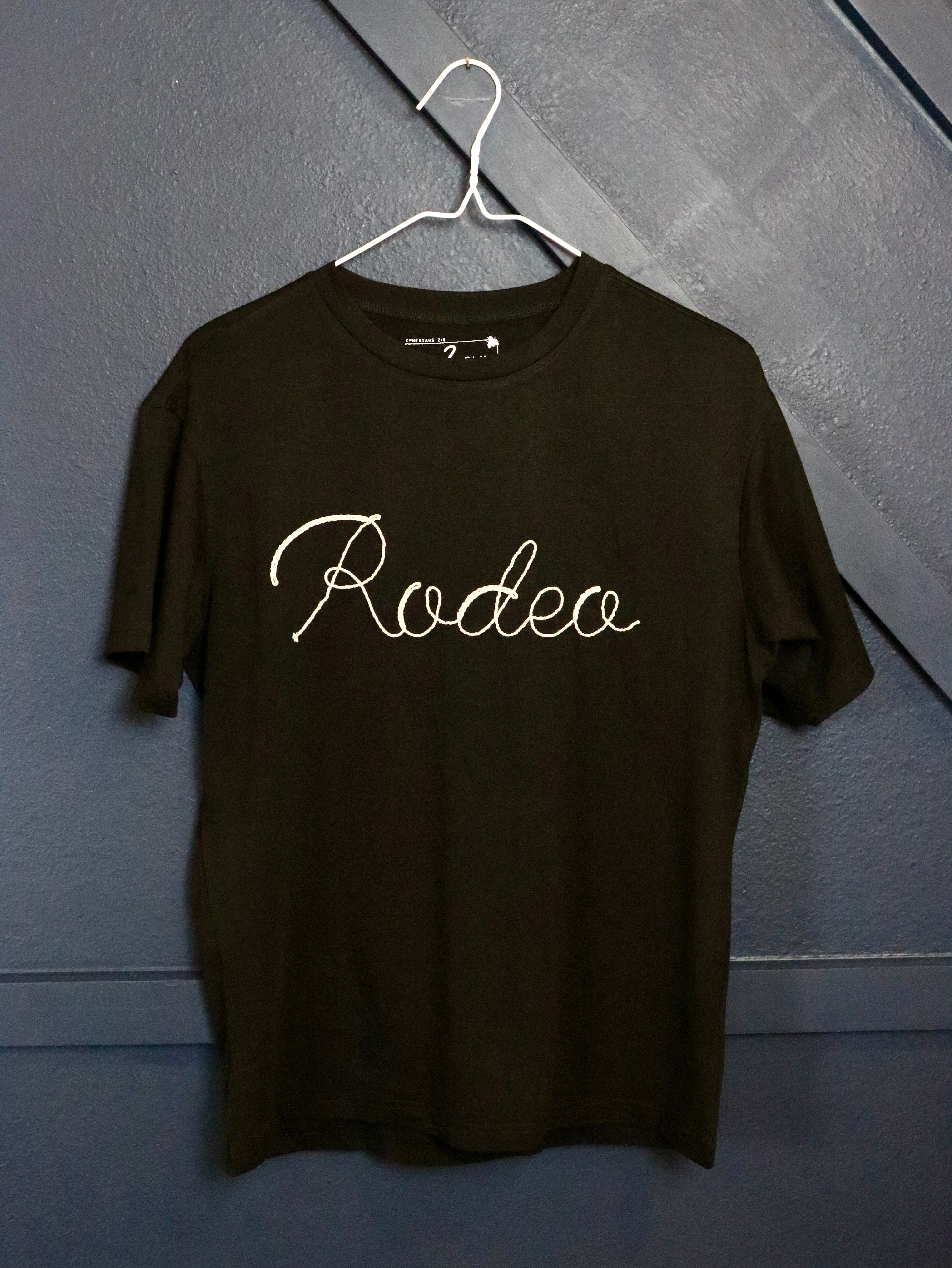 Black t-shirt with rodeo in rope embroidery. 
3D rope embroidery:)
75% Polyester, 20% Rayon, 5% Spandex
True to size.
Made by 2 FLY