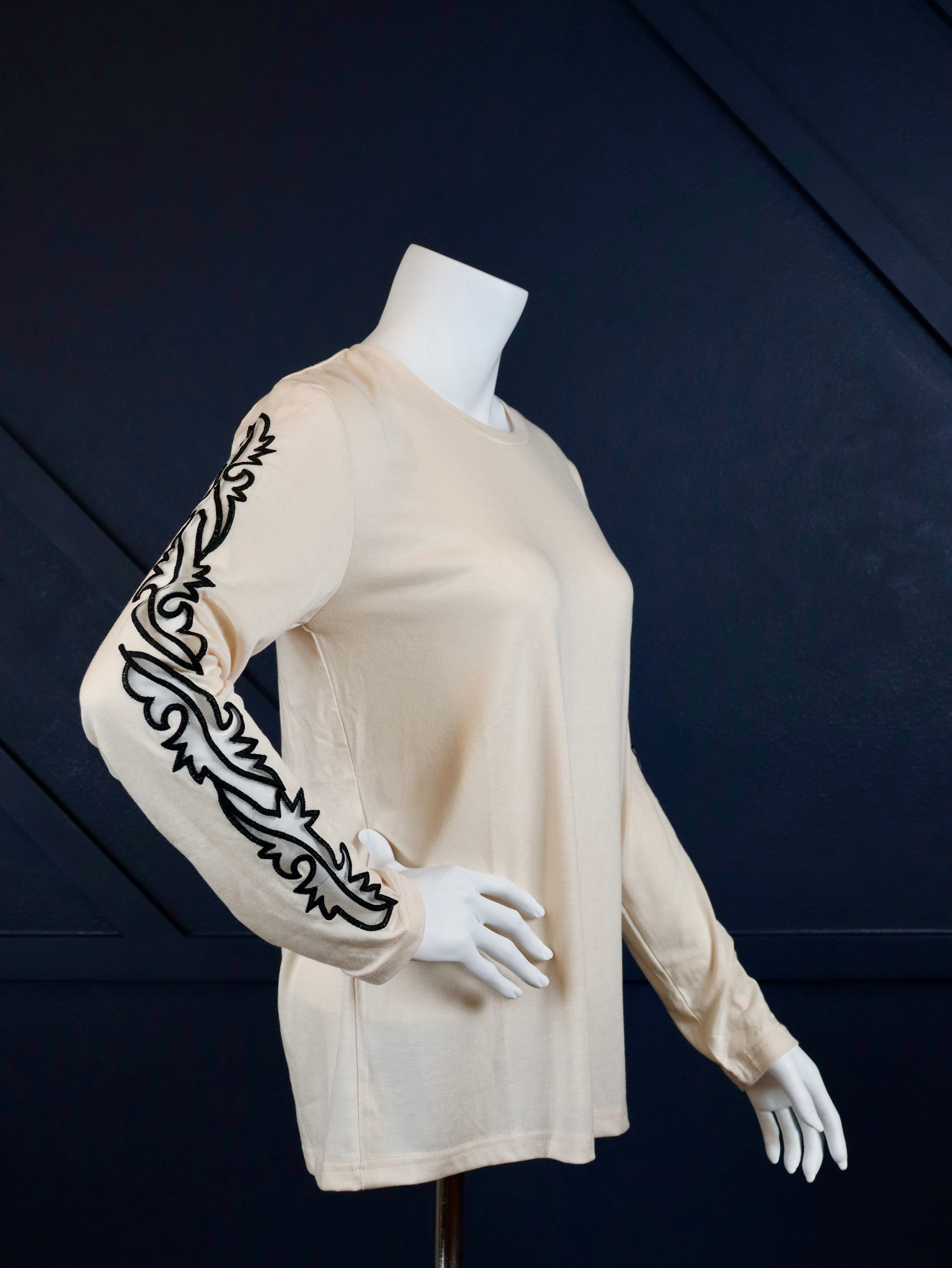 Cream long sleeve top with boot stitch sleeves.

True to size.
75% POLYESTER&nbsp;20% RAYON 5% SPANDEX
Made by 2 Fly
