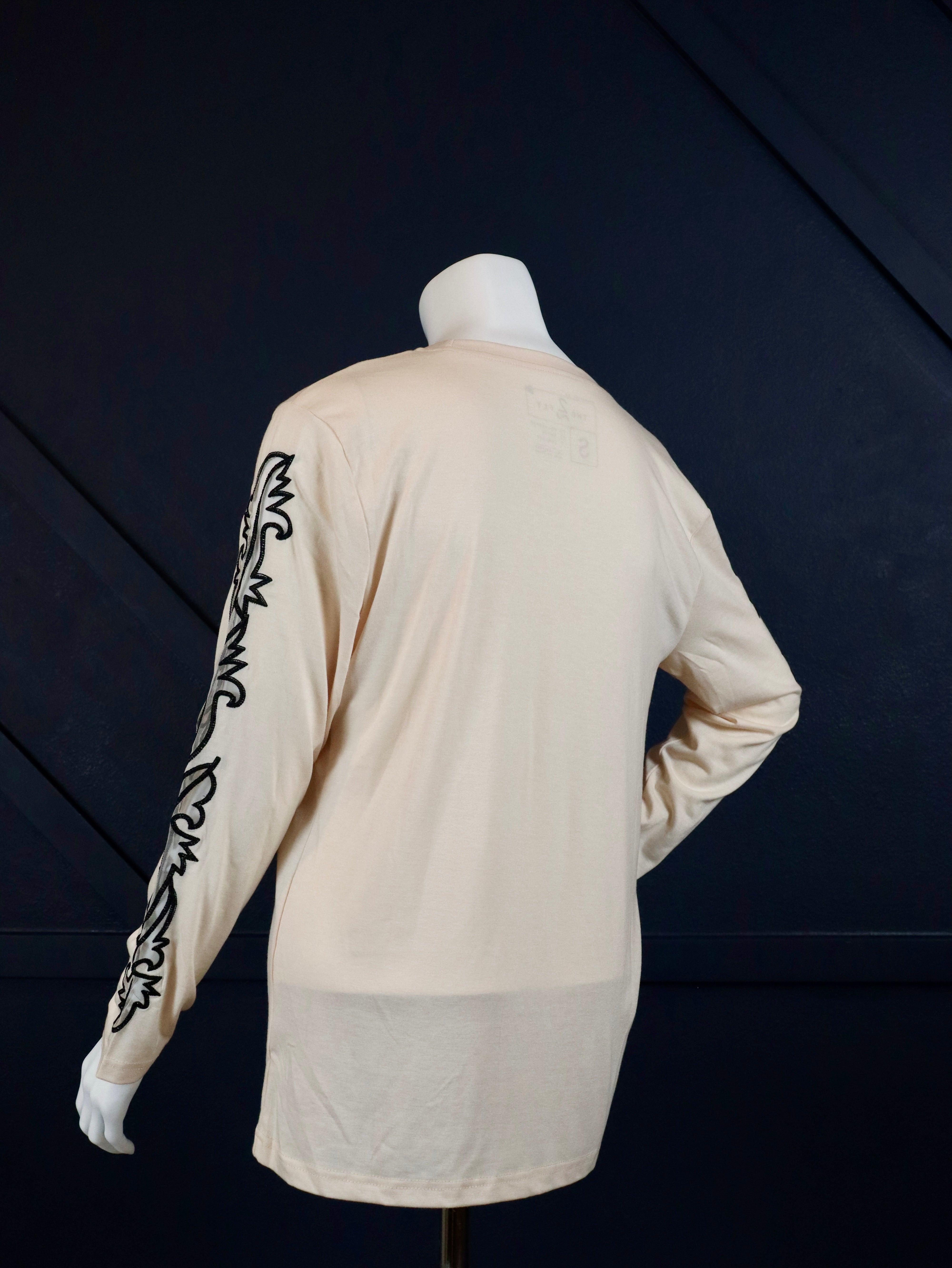 Cream long sleeve top with boot stitch sleeves.

True to size.
75% POLYESTER&nbsp;20% RAYON 5% SPANDEX
Made by 2 Fly
