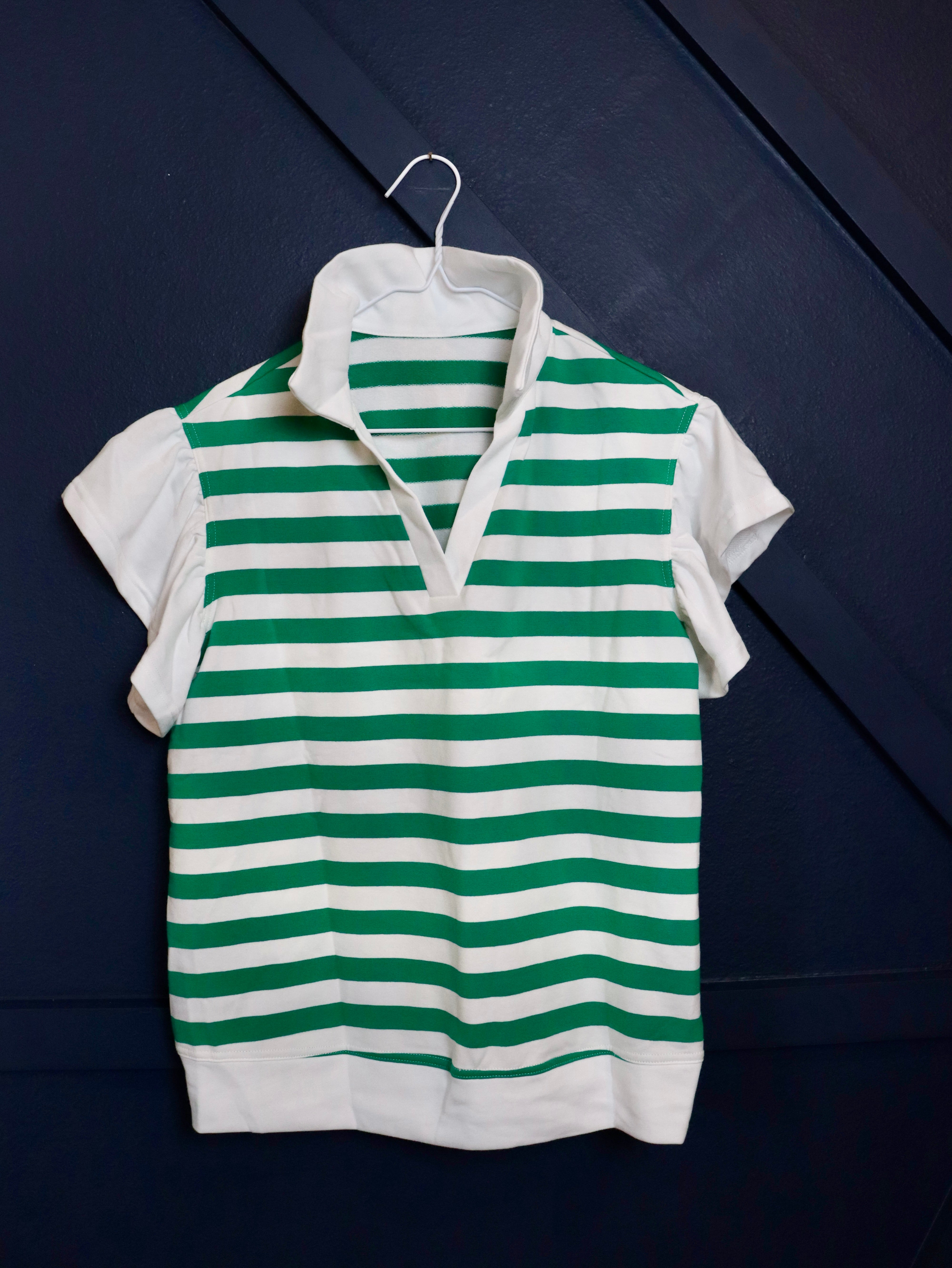 Short ruffle sleeve collared v-neck blouse.

Crafted from a soft breathable 95% cotton 5% elastane&nbsp;blend.
Relaxed fit.&nbsp;
Delicate wash, tumble dry low.