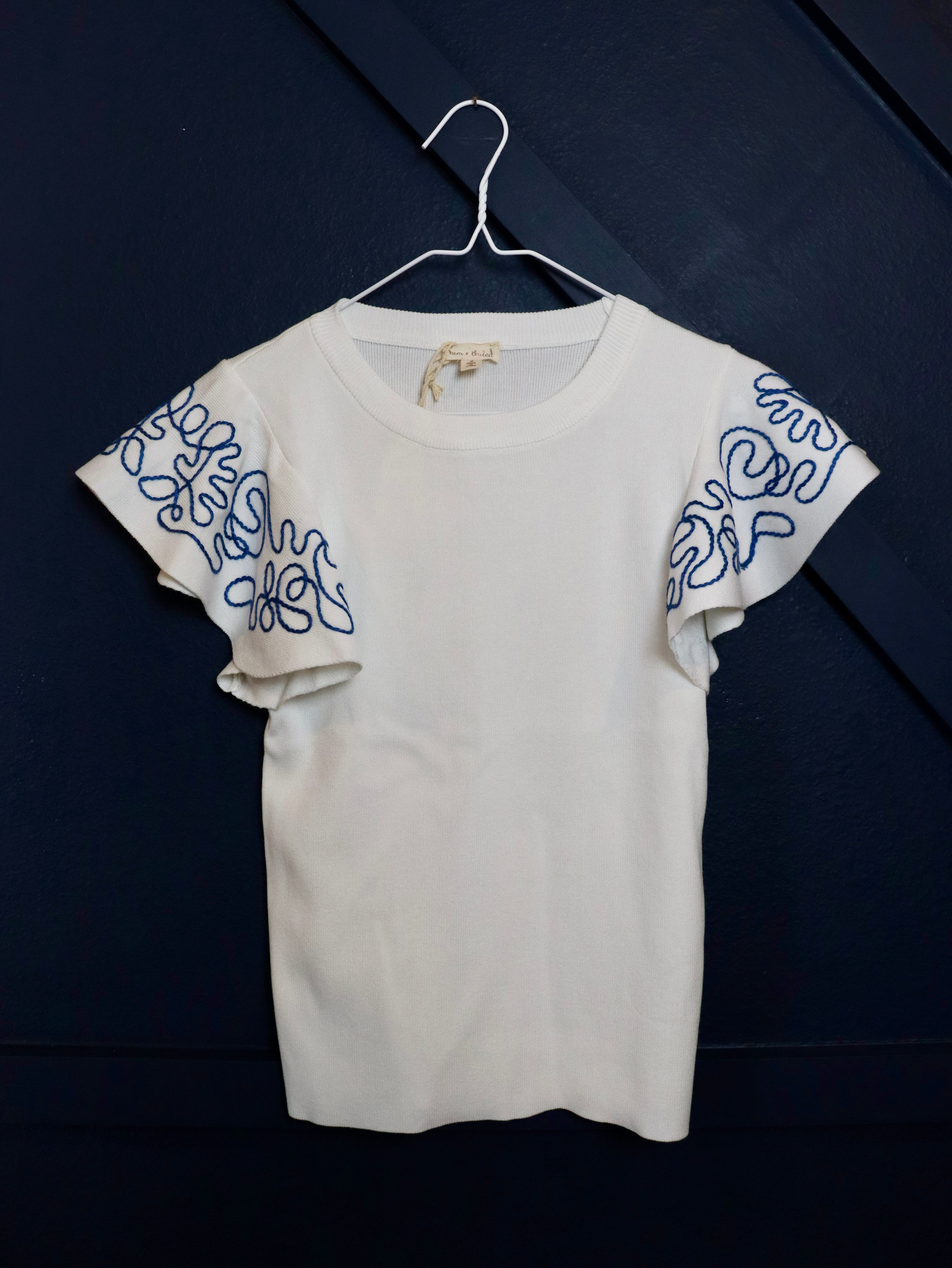 Lightweight woven top with blue embroidered ruffle sleeves.
Blue intricate embroidery on the sleeves.
Everyday breathable woven top.
70% Viscose, 30% Nylon
Small = 2-4 (Bust 35", Waist 27")
Medium = &nbsp;(Bust 37", Waist 29")
Large = (Bust 39", Waist 31")
Made by Hem and Thread.