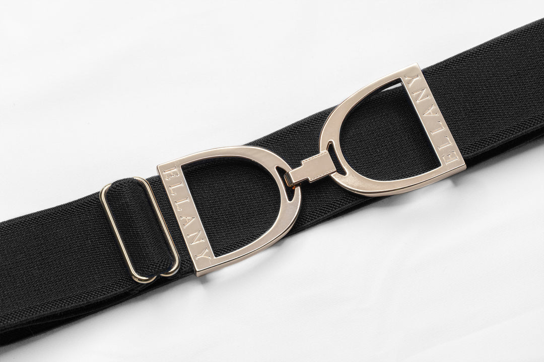 THE belt you didn't know you needed!  1.5" elastic with beautiful gold equestrian buckle. Adjustable 24"-65"!  One size fits most. Ultra comfy, machine washable, no buckle budge, no gap in the back of your pants. Made by Ellany in the USA.