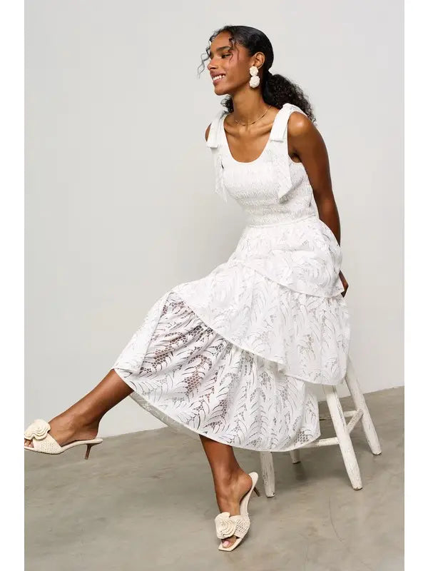 White lace tiered midi dress with bow straps.

X-Small (Size 2-4) Bust: &nbsp;33.5", Waist: &nbsp;26", Hips 36"
Small (Size 4-6) Bust: 35.5", Waist: &nbsp;27.5", Hips: 37.5"
Medium (Size 8-10) Bust: 37.5", Waist: &nbsp;29.5", Hips: 39.5"
Large (Size 12)Bust: 39.5" Waist: &nbsp;31.5", Hips: &nbsp;41.5"
80% Cotton, 20% Polyester
Delicate wash, hang to dry.
Made by Skies are Blue