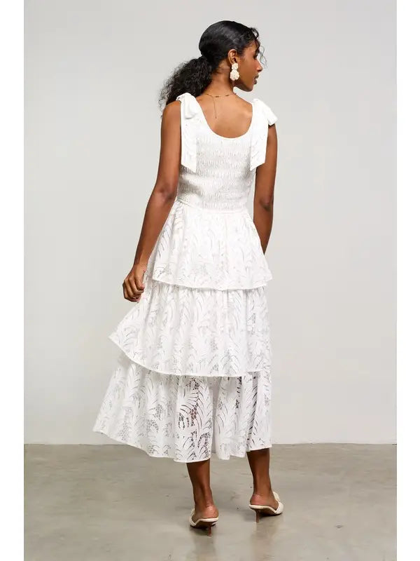 White lace tiered midi dress with bow straps.

X-Small (Size 2-4) Bust: &nbsp;33.5", Waist: &nbsp;26", Hips 36"
Small (Size 4-6) Bust: 35.5", Waist: &nbsp;27.5", Hips: 37.5"
Medium (Size 8-10) Bust: 37.5", Waist: &nbsp;29.5", Hips: 39.5"
Large (Size 12)Bust: 39.5" Waist: &nbsp;31.5", Hips: &nbsp;41.5"
80% Cotton, 20% Polyester
Delicate wash, hang to dry.
Made by Skies are Blue