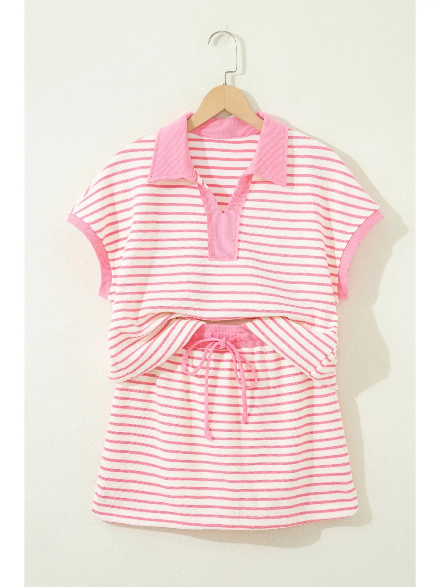Pink polo striped skort set.

Medium (Size 8-10) Bust: 43", Skort Length: 15", Waist: 28.7"
Crafted from a soft, polyester cotton blend.
Charming two-piece set that effortlessly blends preppy style with everyday comfort.
Classic striped polo top features a crisp ribbed collar and short sleeves, perfectly paired with a drawstring elastic waist mini skort complete with built-in shorts for versatile wear.
Crafted from soft, breathable cotton-blend fabric, this set keeps you cool and comfortable through warm da