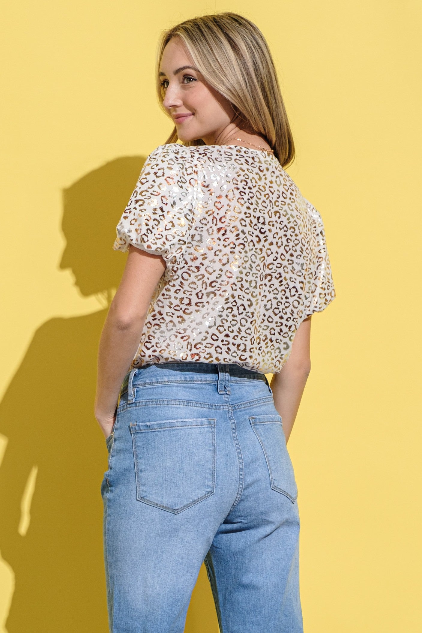 The foil leopard print on cream makes this top extra special!  Bodysuit (but you can wear it as a top that tucks in and stays put) 100% Polyester, Brief:  95% Rayon, 5% Spandex Made by And the Why Small (0-2)  Medium (4-6)  Large (8-10)  X-Large (10-12)