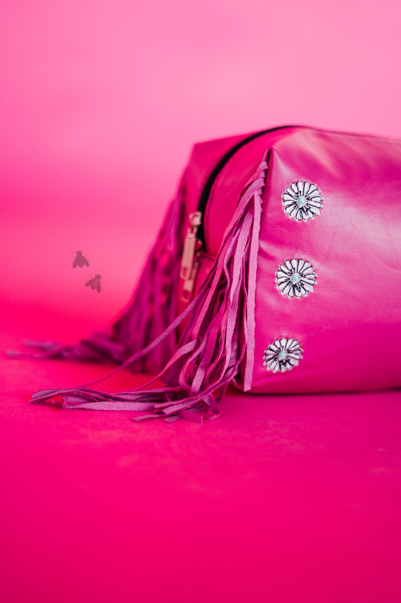 Pink faux leather pouch with FRINGE.;)  Great make up bag and GIFT.    Faux leather with embroidered conchos 8" x 4" x 6" Easy to clean Made by 2 FLY