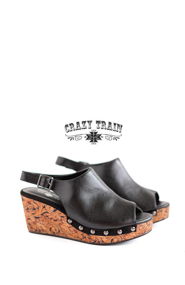 Black with tooled print wedge. Buckle closure and peep toe.  3.25" heel Made by CRAZY TRAIN