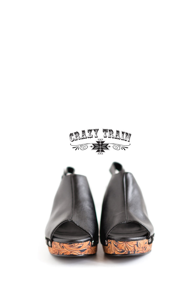 Black with tooled print wedge. Buckle closure and peep toe.  3.25" heel Made by CRAZY TRAIN