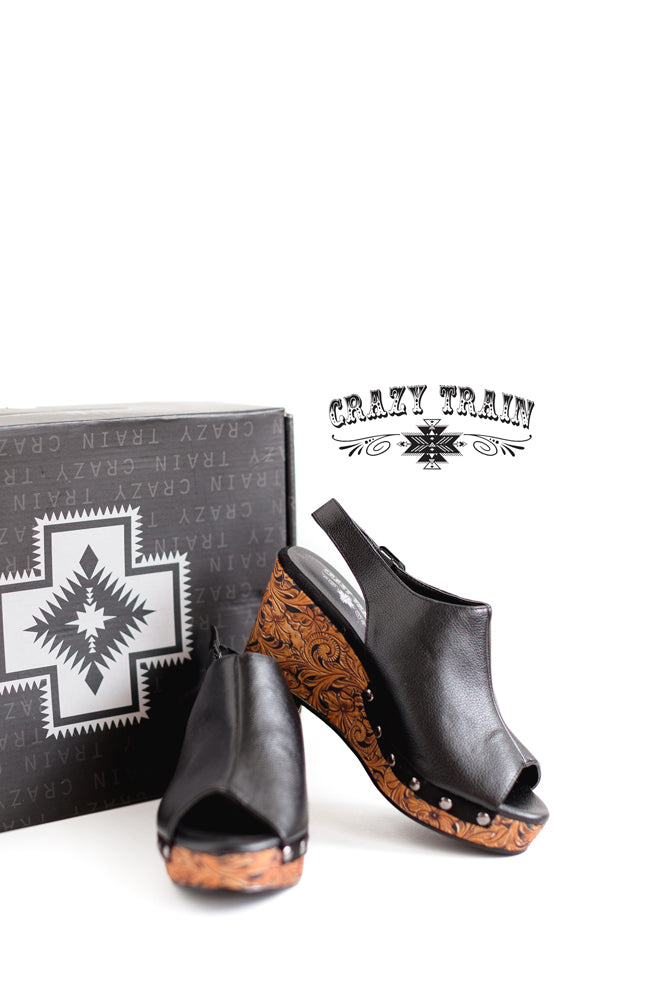 Black with tooled print wedge. Buckle closure and peep toe.  3.25" heel Made by CRAZY TRAIN